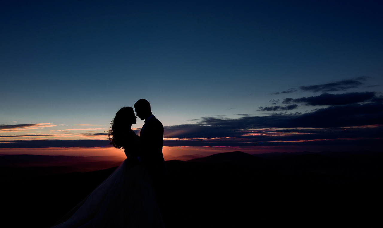 couple-hugs-before-violet-evening-sky-mountains.jpg