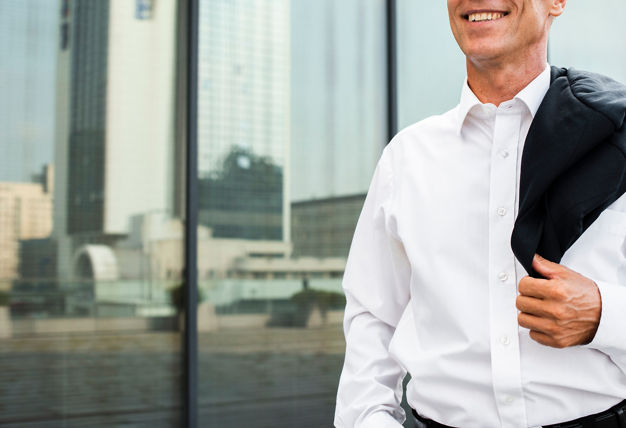 close-up-businessman-near-glass-building.jpg