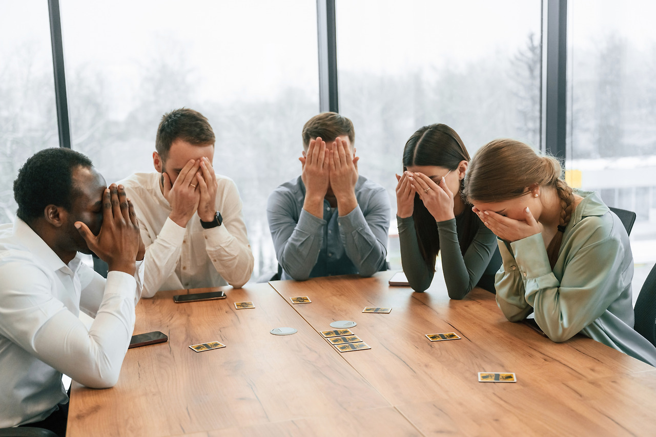covering-eyes-with-hands-playing-card-game-team-office-workers-are-together-indoors.jpg