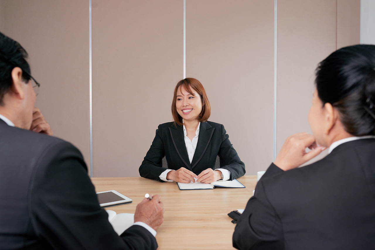 confident-asian-businesswoman-sitting-meeting-office-smiling.jpg