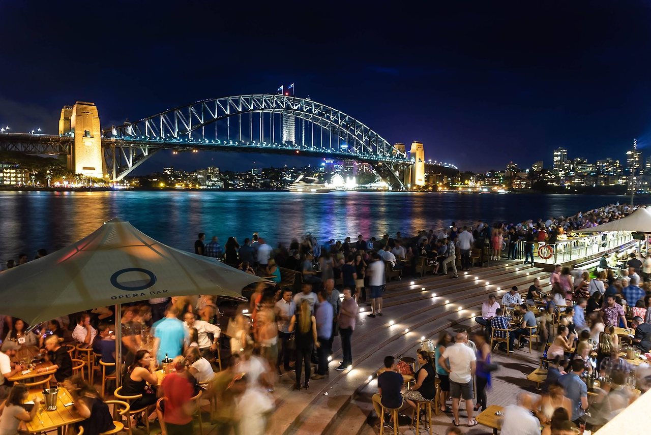 people-sitting-and-standing-near-bridge-during-nighttime-762905.jpg