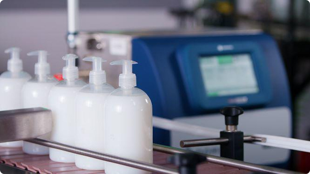 Ax130i on production coding onto bottles.jpg