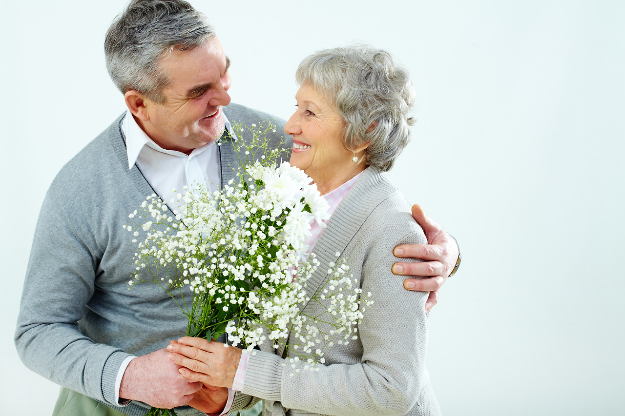 graphicstock-portrait-of-husband-giving-bouquet-of-flowers-to-wife-at-womans-day_SAZJT8sYbW.jpg