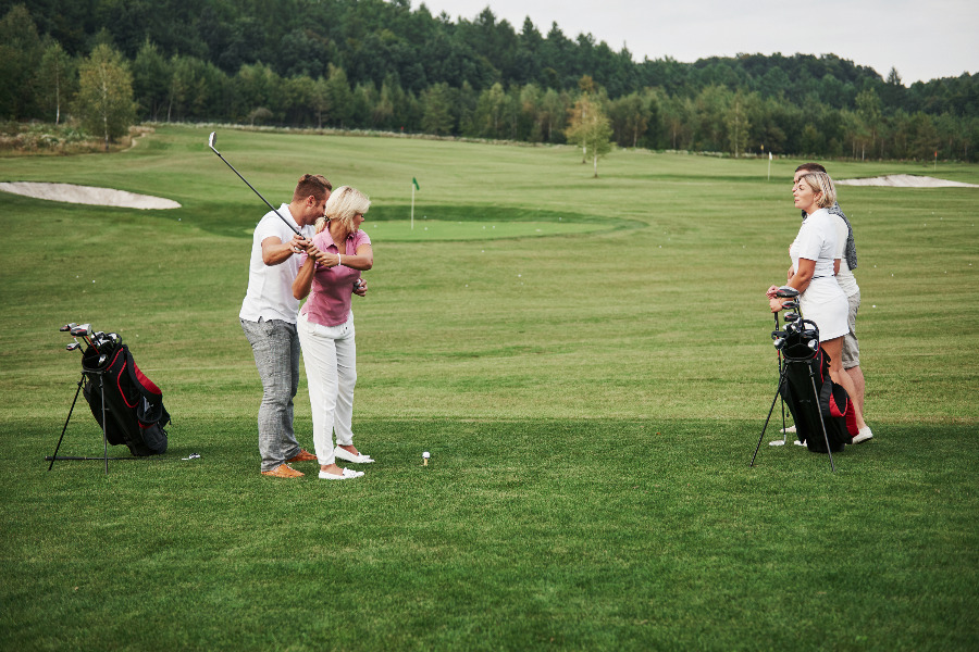 girl-playing-golf-and-hitting-by-putter-on-green-2021-08-29-18-28-07-utc.jpg