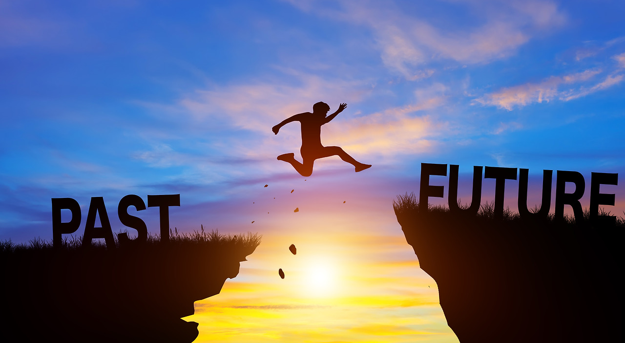 vecteezy_silhouette-man-jumping-from-past-to-future-with-sunrise-go_11063483 (1).jpg