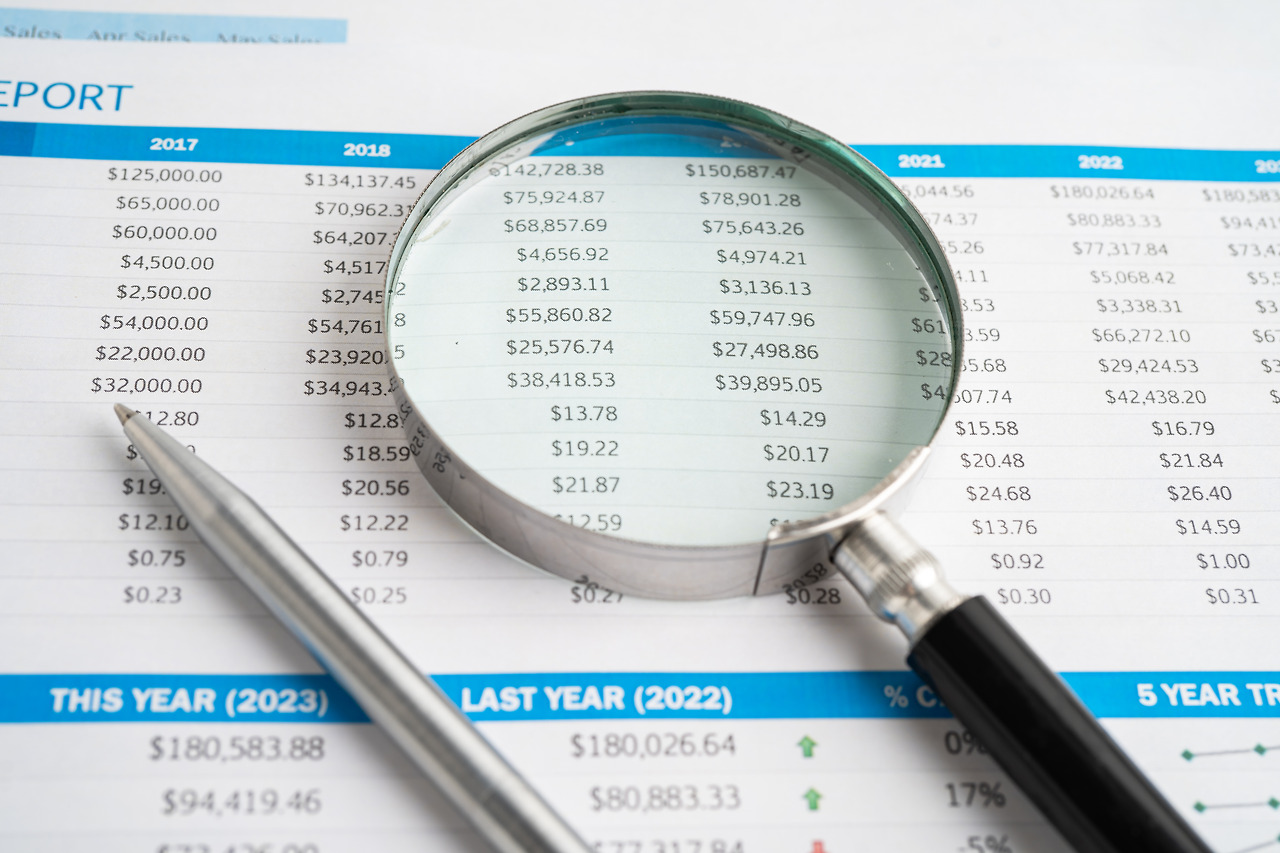 vecteezy_magnifying-glass-on-spreadsheet-and-graph-paper-financial_46408821.jpg