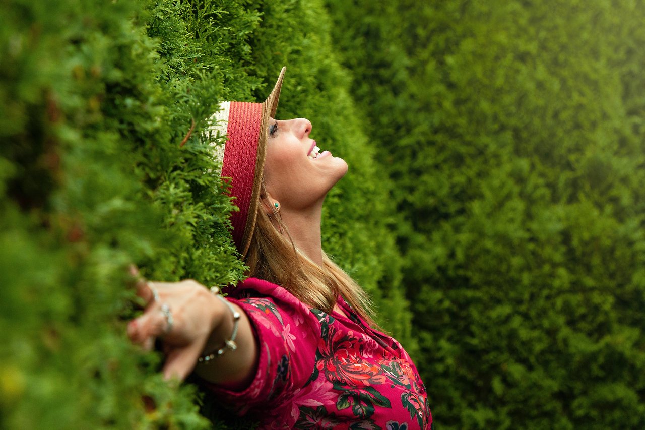 woman-in-red-floral-shirt-lying-on-grass-field-1429395.jpg