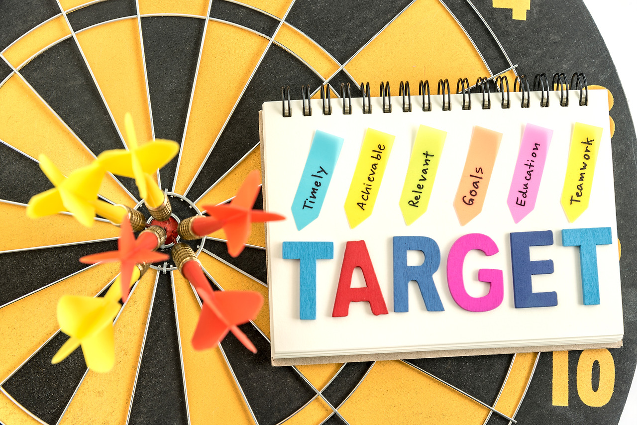 six-dart-bullseye-with-words-target-notebook-with-handwriting-timely-achievable-relevant-goals-education-teamwork-dartboard-background-business-success-concept.jpg