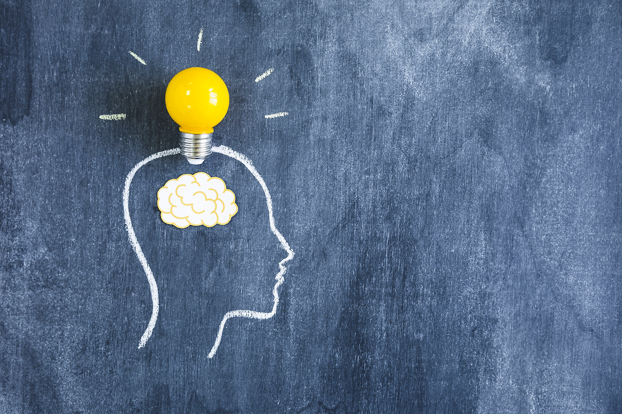 yellow-light-bulb-paper-cutout-brain-outline-face-made-with-chalk-blackboard.jpg