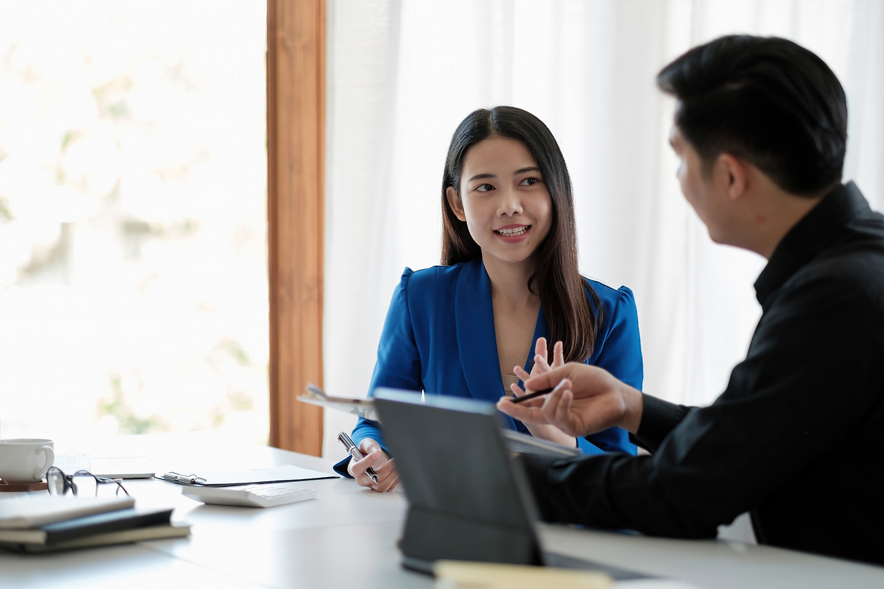 two-colleagues-discussing-data-with-document-data-desk-table-close-up-business-people-meeting (1).jpg