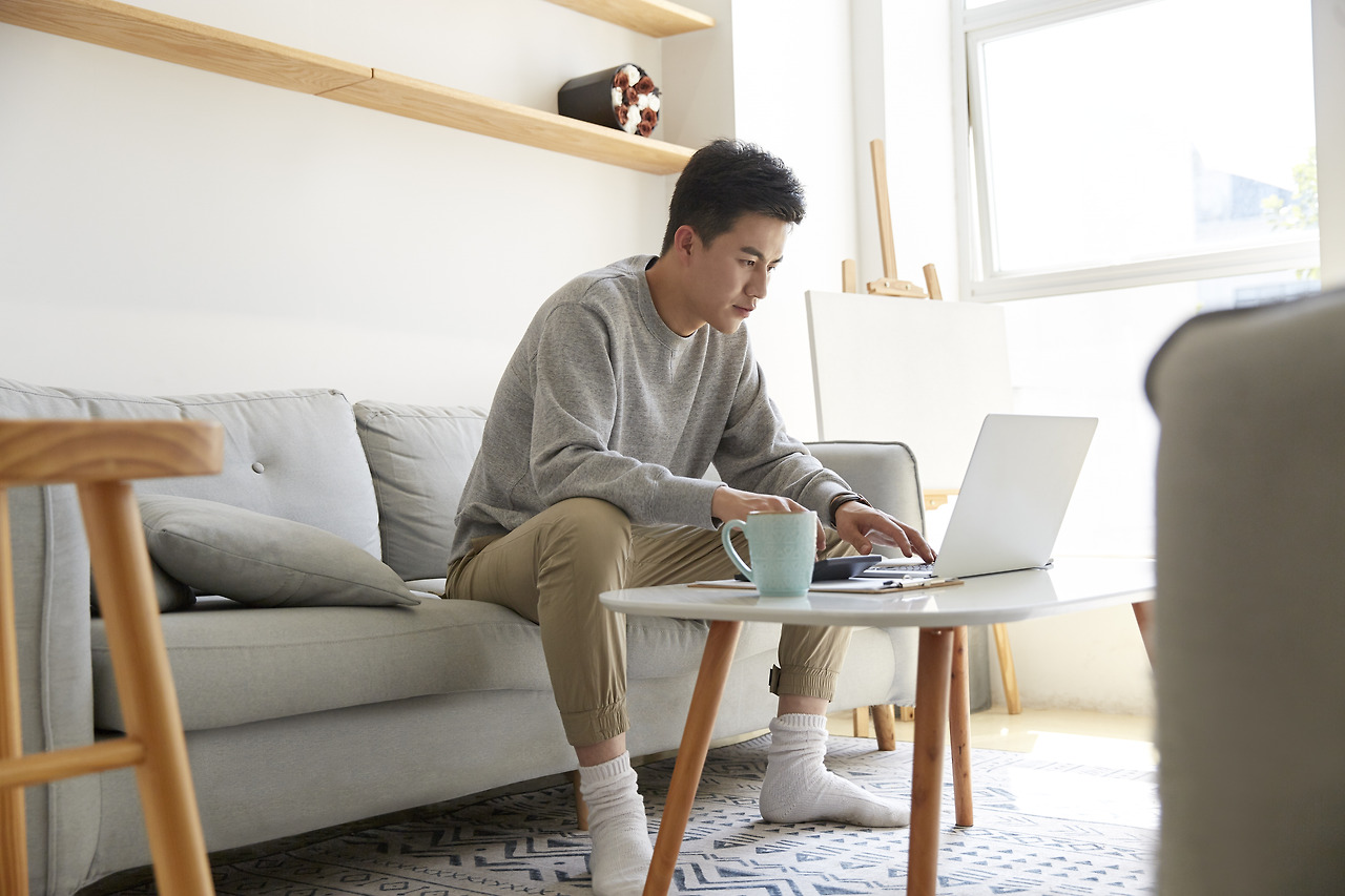 young-asian-business-man-working-home-using-laptop-computer.jpg