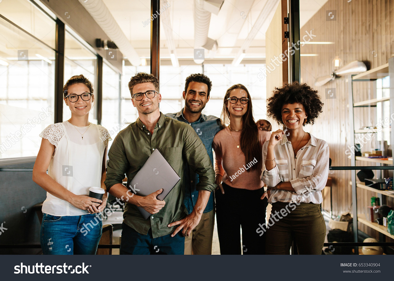 stock-photo-portrait-of-successful-creative-business-team-looking-at-camera-and-smiling-diverse-business-653340904.jpg
