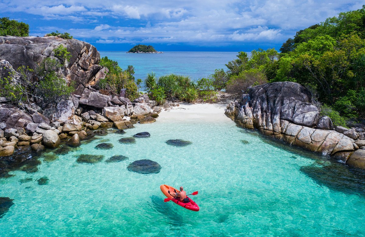 Aerial-drone-view-of-in-kayak-in-crystal-clear-lagoon-sea-water-during-summer-day-near-Koh-Lipe-island-in-Thailand-photo-via-Depositphotos.jpg