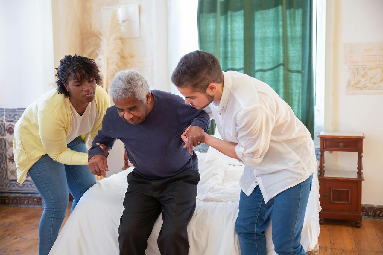 elderly-man-assisted-by-family.jpg
