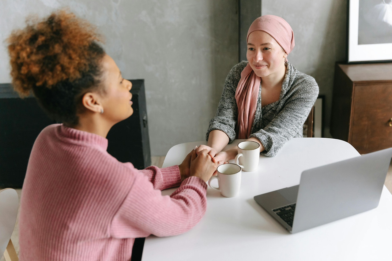 two-women-holding-hands-talking.jpg.jpg