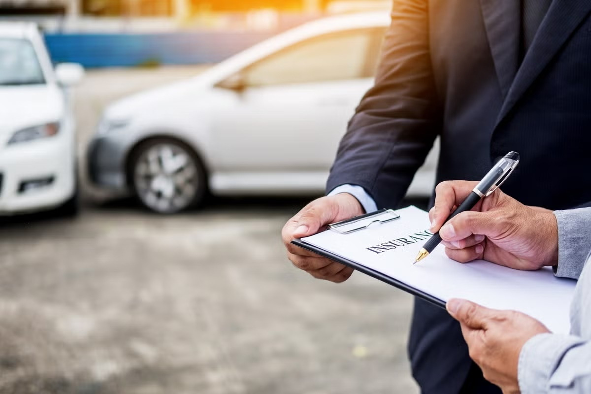 midsection-of-man-signing-car-insurance-form-royalty-free-image-1583557935.jpg