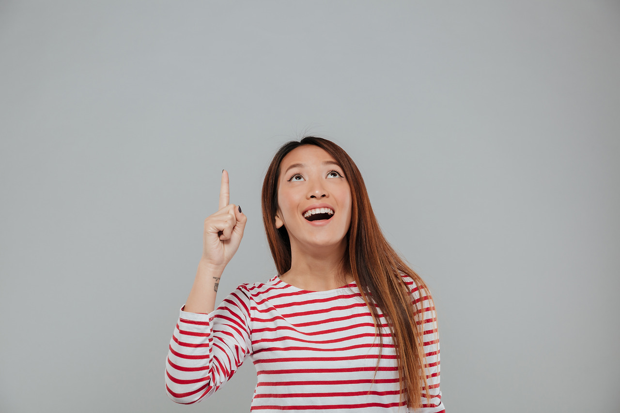 portrait-n-amused-happy-asian-woman-pointing-finger.jpg