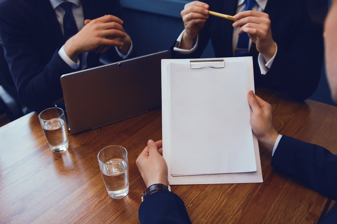 business-people-sitting-desk-conference-hall-working-with-papers-laptop.jpg