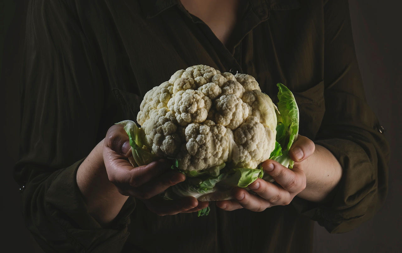 cauliflower-cabbage-with-leaves-in-female-hands-a-2023-11-27-05-16-22-utc.jpg