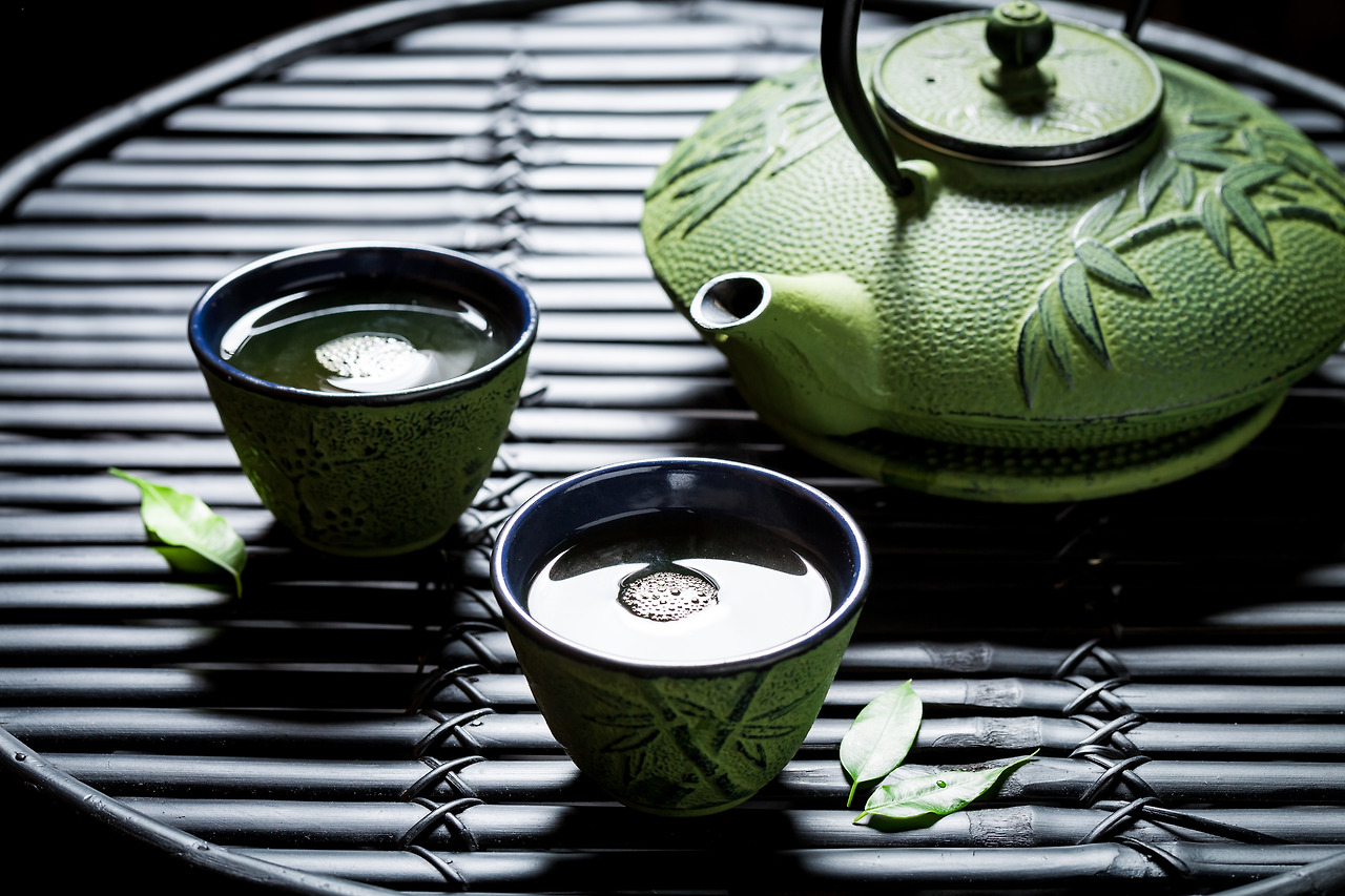 closeup-of-green-tea-on-black-bamboo-table-2023-11-27-05-01-15-utc.jpg
