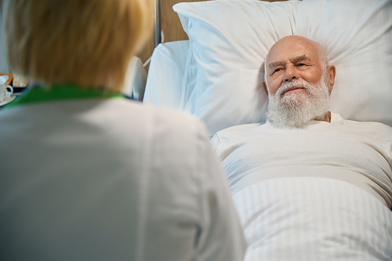 old-man-lying-in-a-hospital-looks-at-a-nurse-2024-06-10-22-18-02-utc.jpg