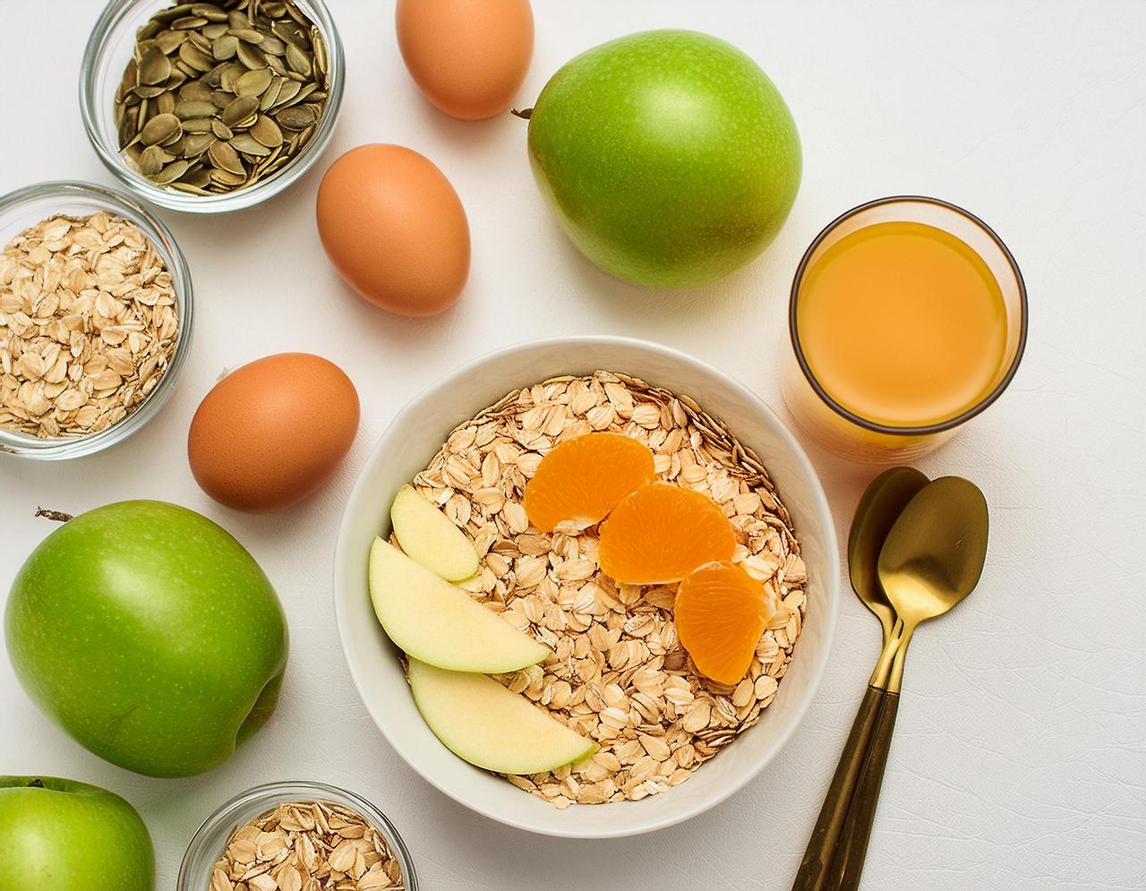 Firefly breakfast on the white table, oatmeal and cut fruits and the eggs 28912.jpg