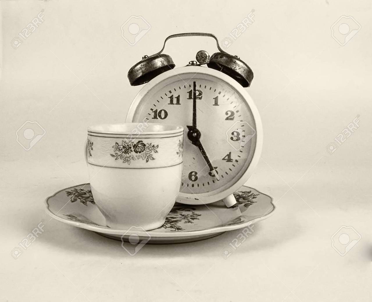 56301304-tea-cup-with-vintage-alarm-clock-shows-5-o-clock-tea-time.jpg