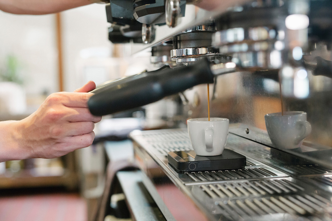 close-up-of-a-man-standing-in-front-of-an-espresso-2023-11-27-05-02-06-utc.jpg