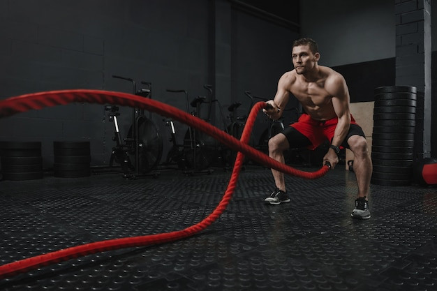 young-crossfit-athlete-doing-battle-ropes-exercise-at-the-fitness-gym-man-training-workout-with-rope-the-sport-motivation-concept-copy-space_403156-1.jpg