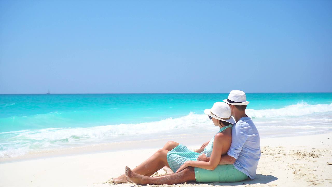 young-couple-on-white-beach-during-summer-vacation-happy-lovers-enjoy-their-honeymoon-video.jpg