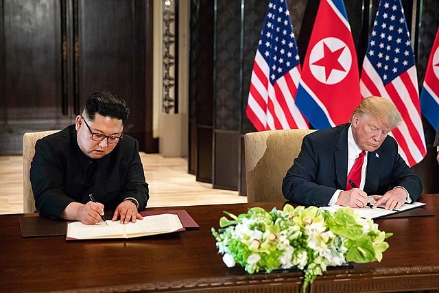 Trump_and_Kim_signing_joint_statement_White House.jpg