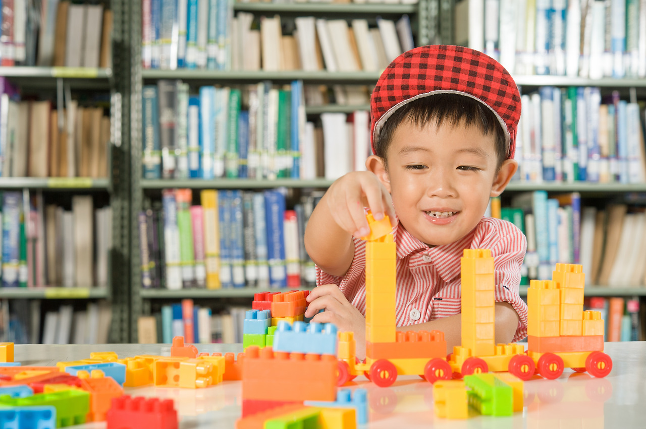 boy-playing-with-plastic-blocks-library-room-school.jpg