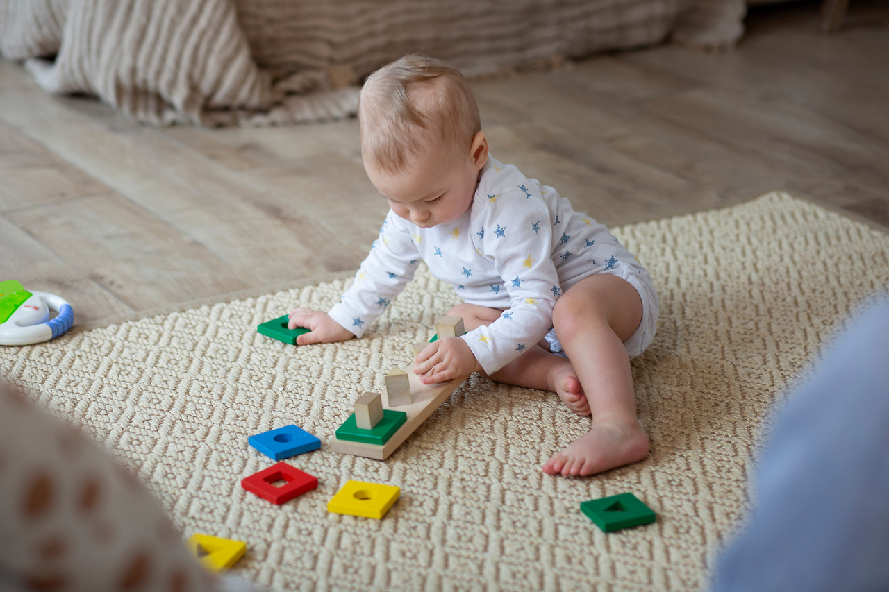 full-shot-cute-baby-playing-floor.jpg