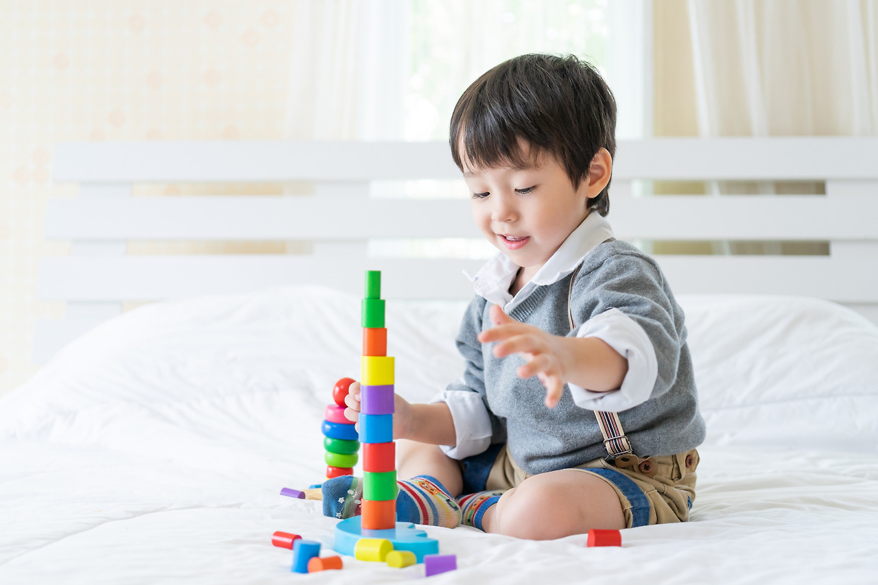 little-boy-joyful-with-colorful-wooden-learning-toy.jpg