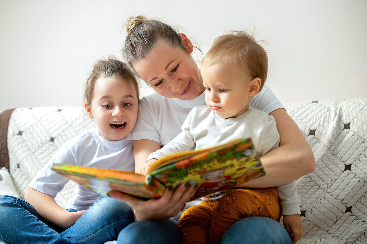 mom-her-two-children-are-reading-book-home-sofa-happy-smiling.jpg