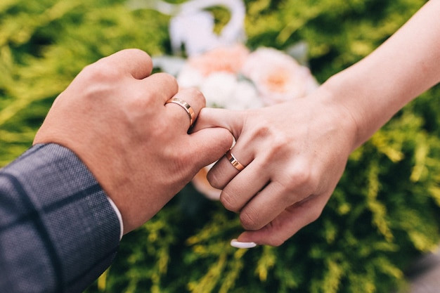 picture-man-woman-with-wedding-ringyoung-married-couple-holding-hands-ceremony-wedding-day-newly-wed-couples-hands-with-wedding-rings_609048-260.jpg