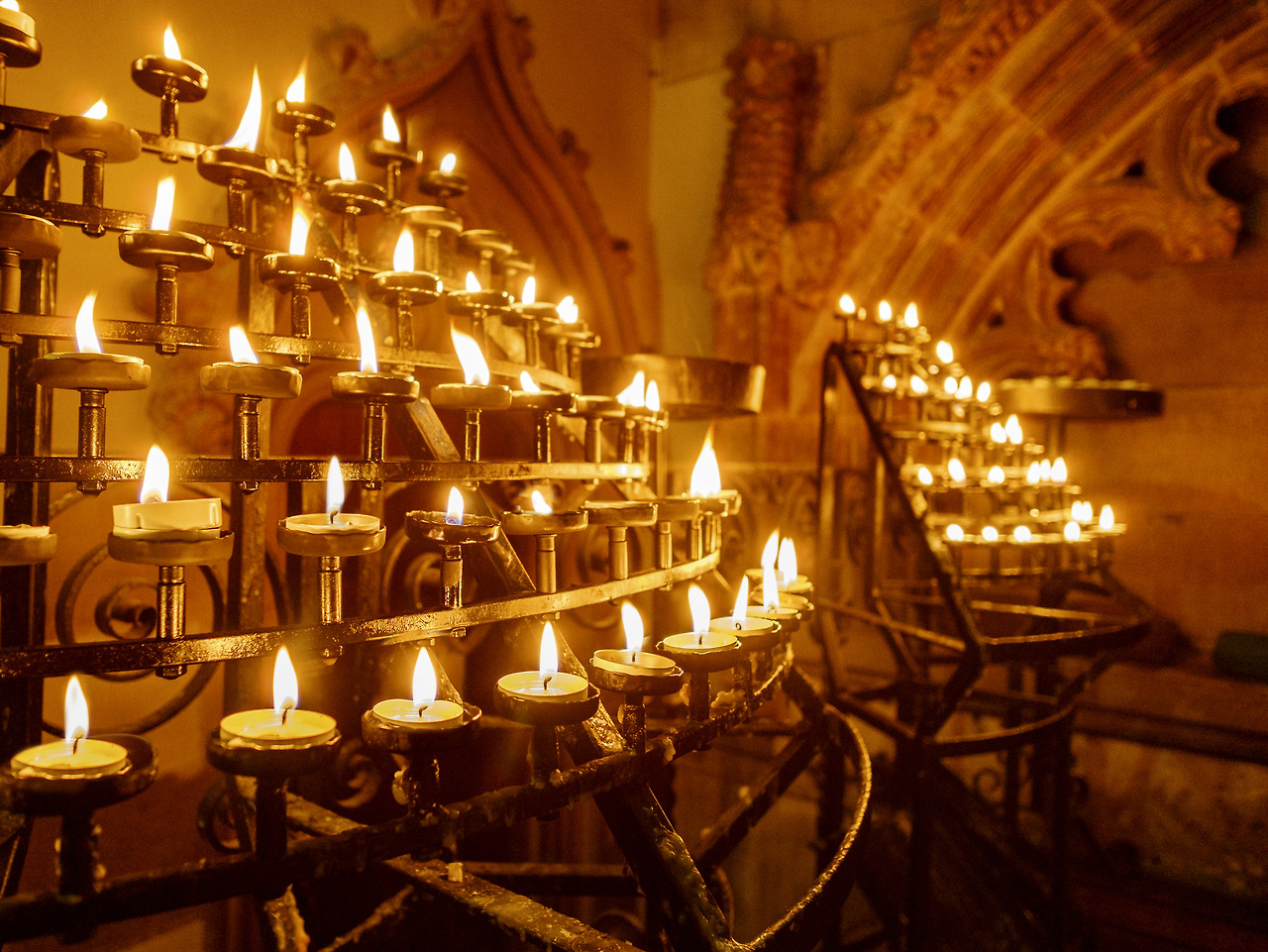 lit-candles-in-racks-in-a-historic-church-2023-11-27-05-15-19-utc.jpg