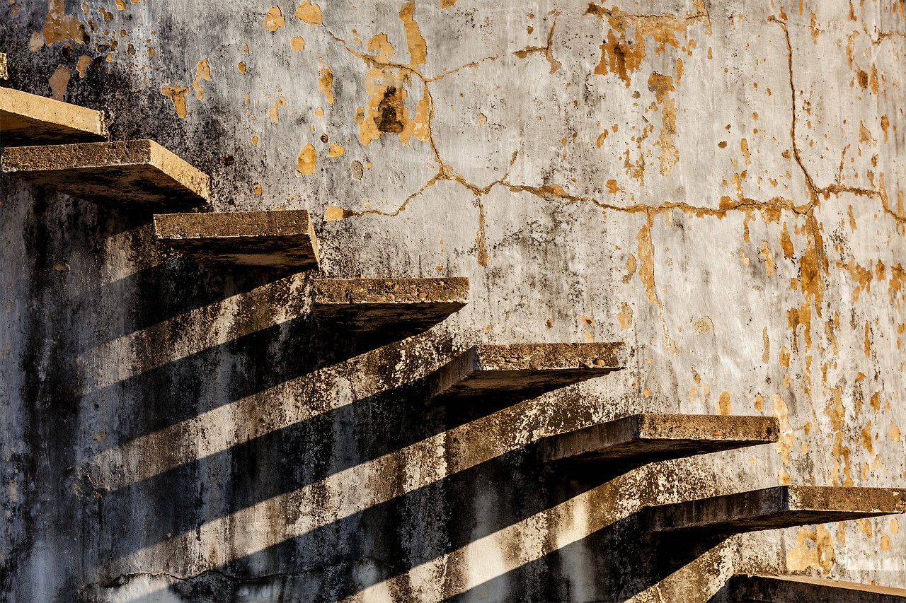 stairs-casting-shadow-on-old-weathered-wall-2023-11-27-05-28-56-utc.jpg