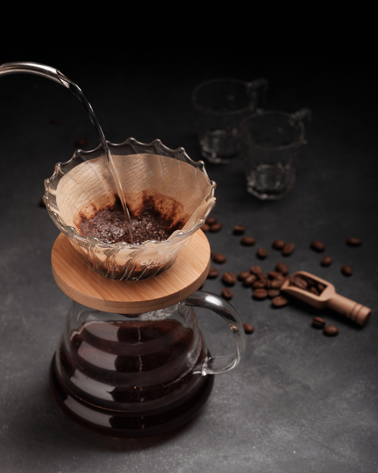 vertical-shot-person-pouring-coffee-glass-black-background.jpg