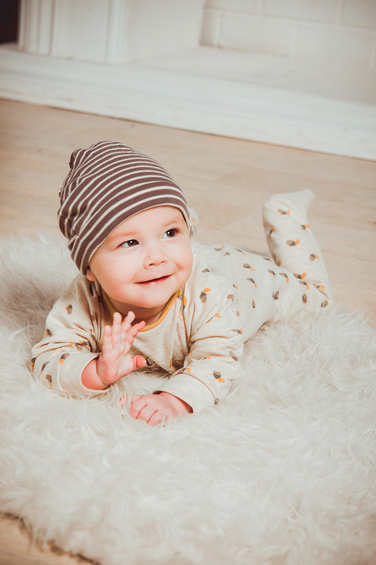 smiling-baby-lying-on-white-mat-1648377.jpg