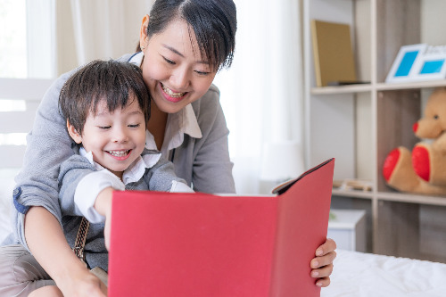 young-mother-and-little-son-reading-book-at-home.jpg