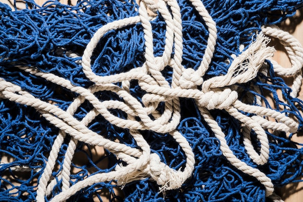 overhead-view-blue-fishing-net-with-white-rope_23-2148189249.jpg