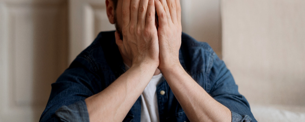 front-view-man-covering-his-face.jpg