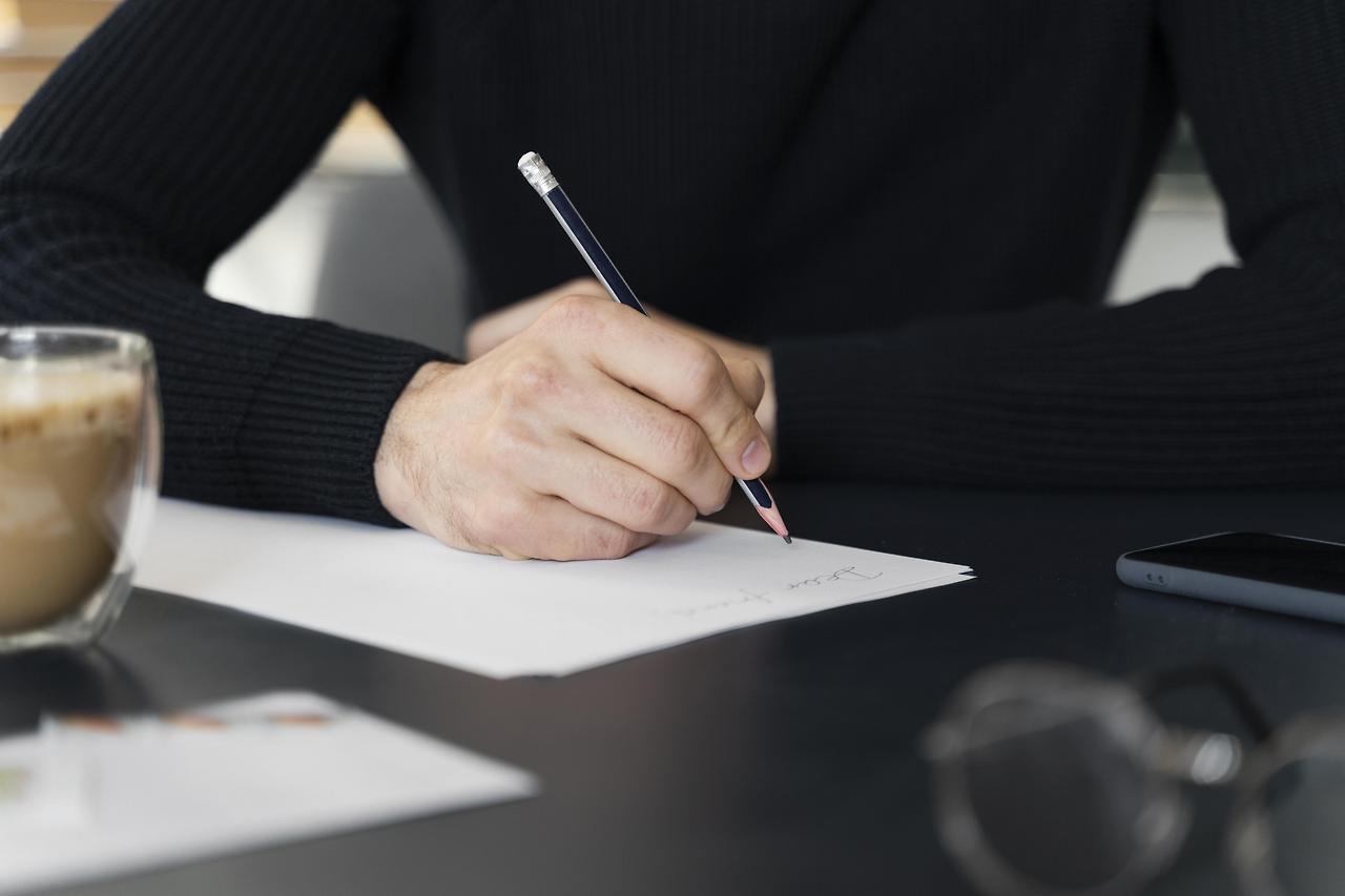 close-up-man-writing-letter.jpg