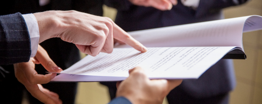 cropped-view-businesswomen-reading-document.jpg