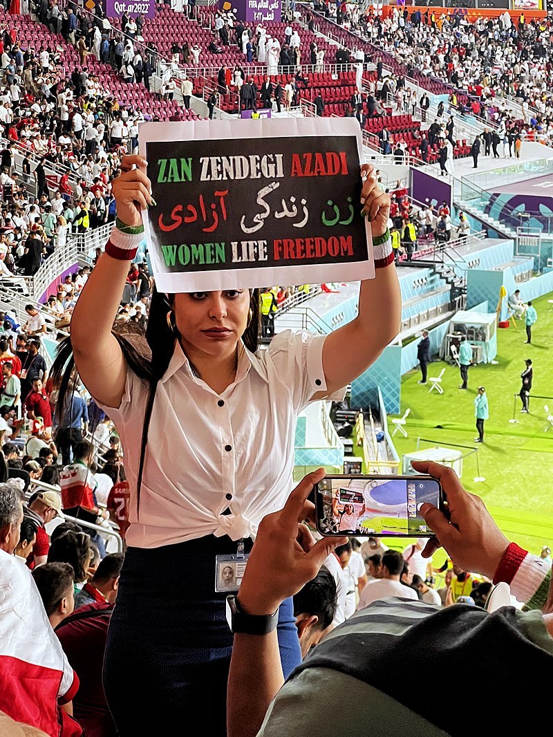 An Iranian fan showing a banner with Woman, Life, Freedom slogan.jpg