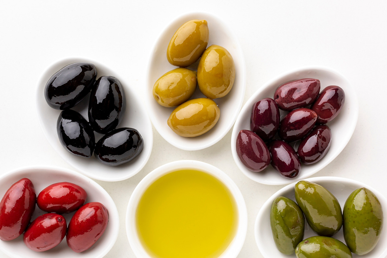 close-up-red-black-yellow-purple-olives-plates-with-leaves-olive-saucer-cp.jpg