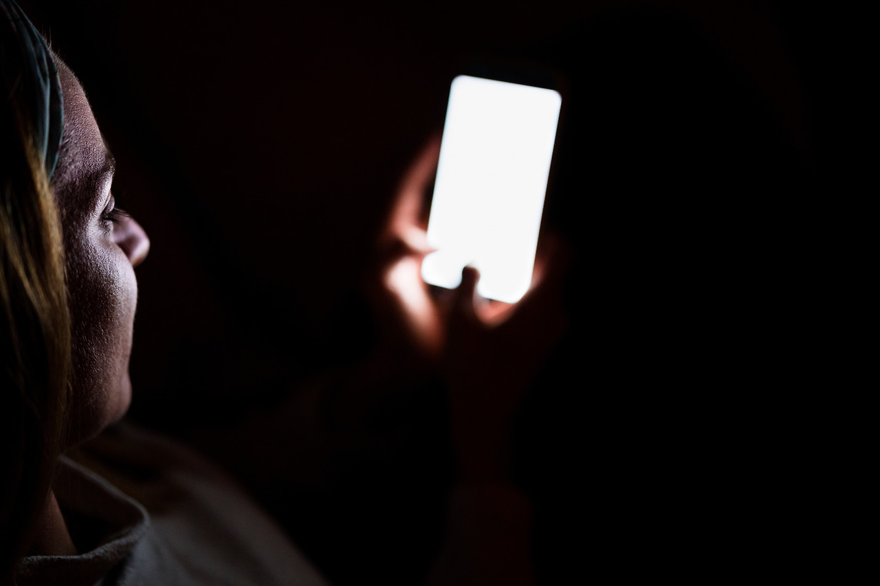 young-woman-at-home-using-mobile-phone-night-time-2024-11-02-23-49-48-utc.jpg