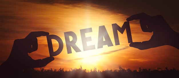 dream-human-hands-holding-black-silhouette-word_764664-22895.jpg