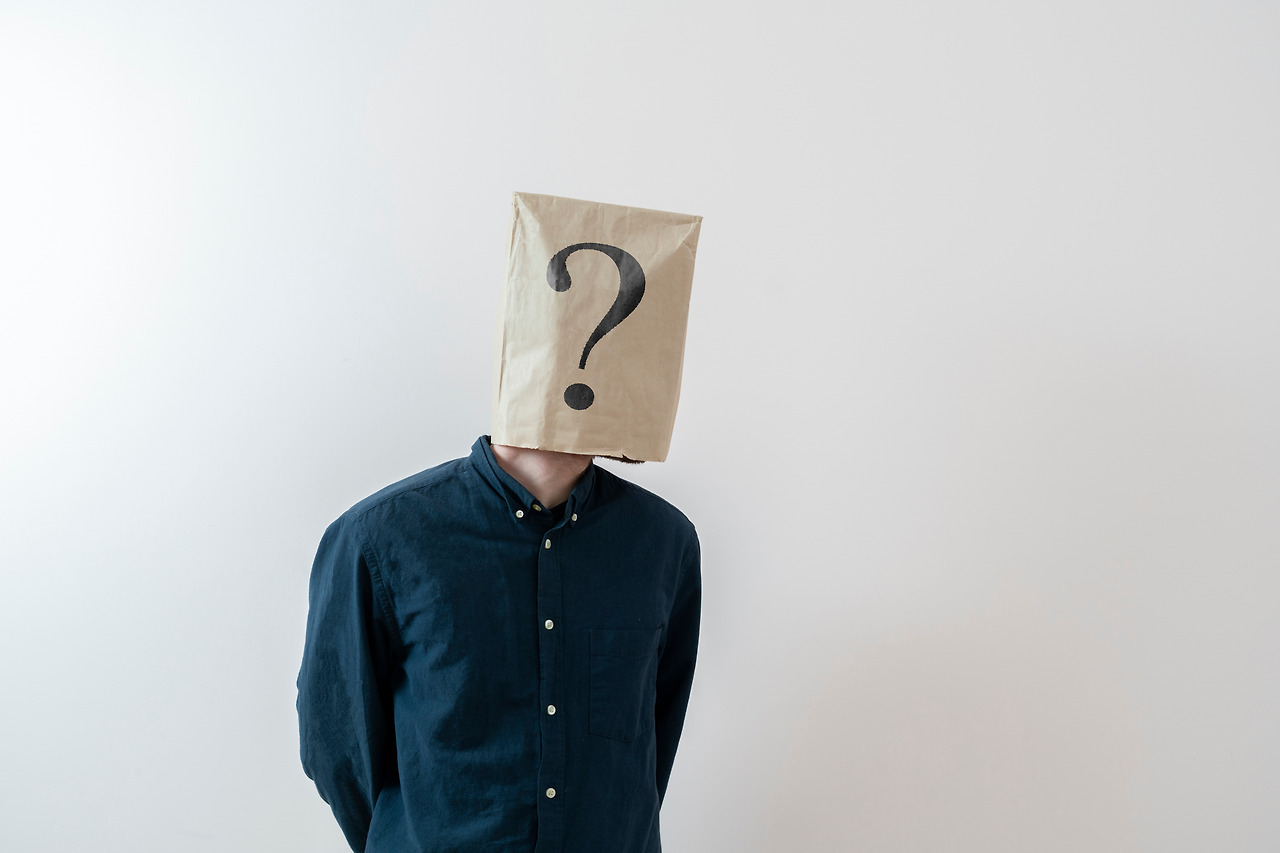 a-person-with-a-paper-bag-on-the-head-with-question-mark-sign-symbol-of-problem (1).jpg